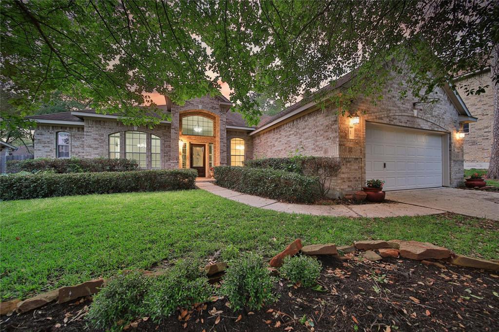 a front view of a house with a yard and potted plants