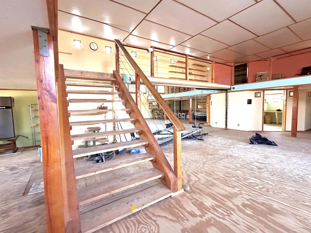 a view of a room with wooden floor and windows