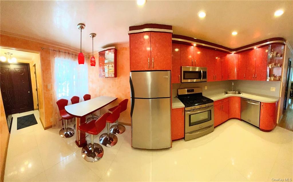 a kitchen with refrigerator and mirror