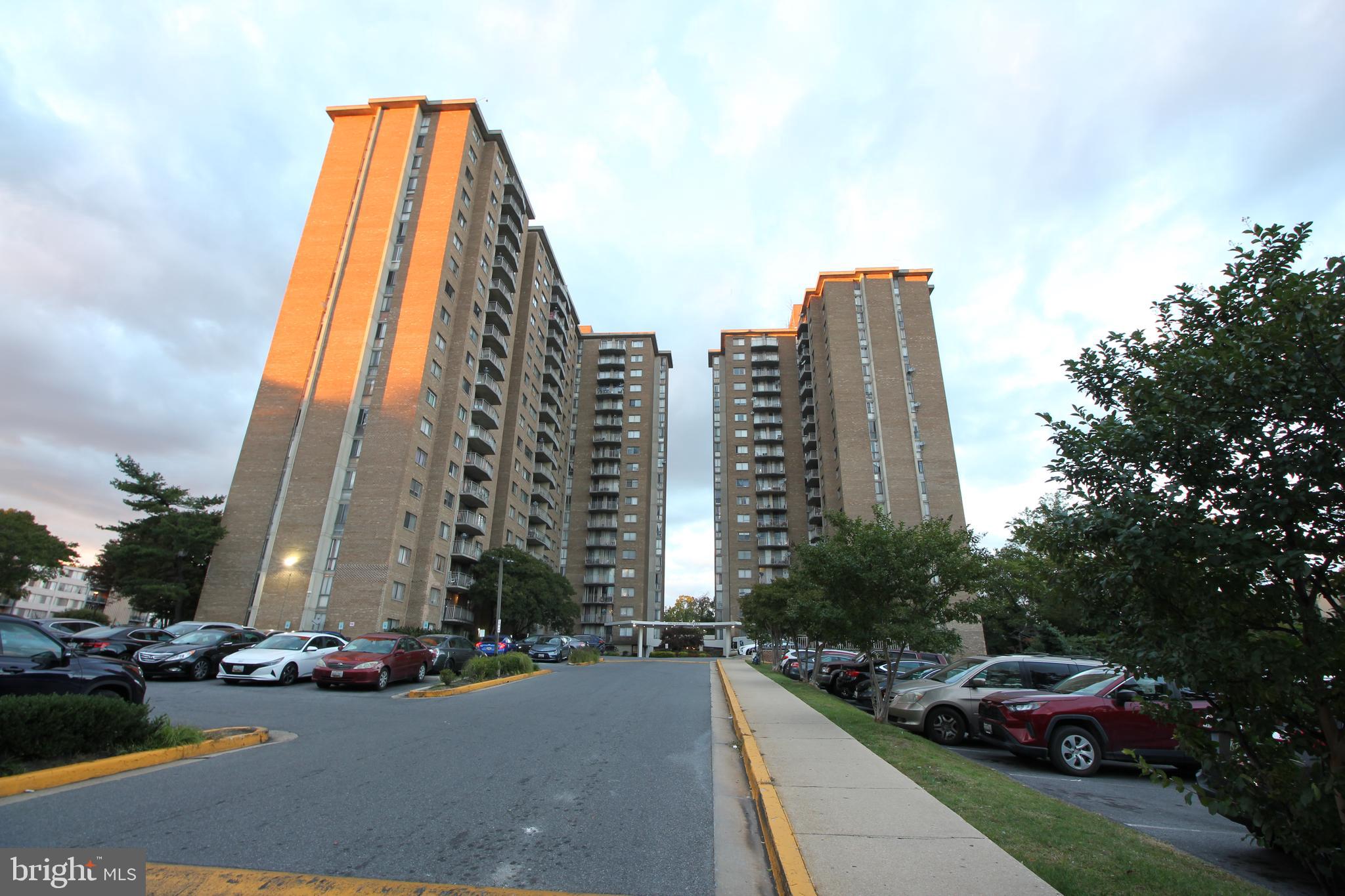 a front view of a residential apartment building with a yard