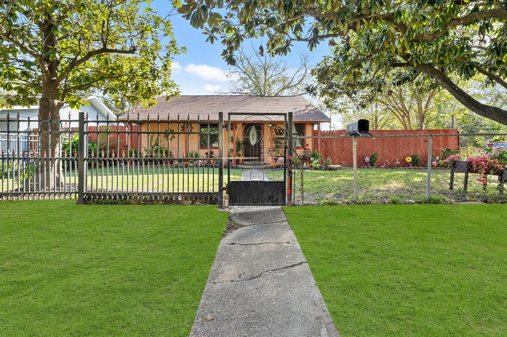 a front view of a house with a garden and plants