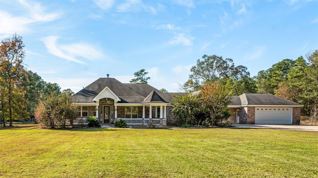 Charming single-story home with a spacious lawn, mature trees, and a welcoming front porch. Features a two-car garage and a serene, wooded backdrop. Perfect for those seeking tranquility and space.