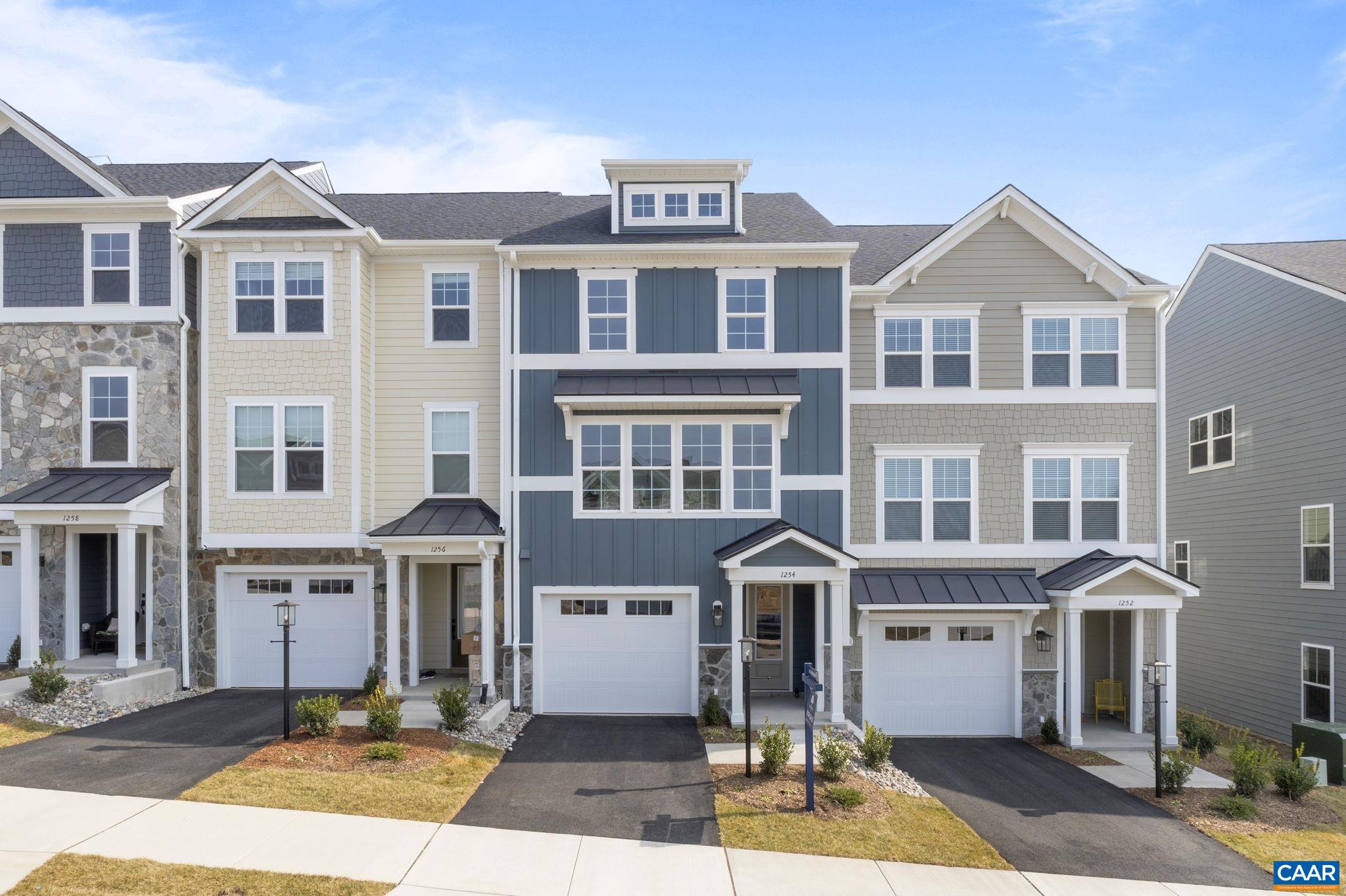 a front view of a residential apartment building with a yard