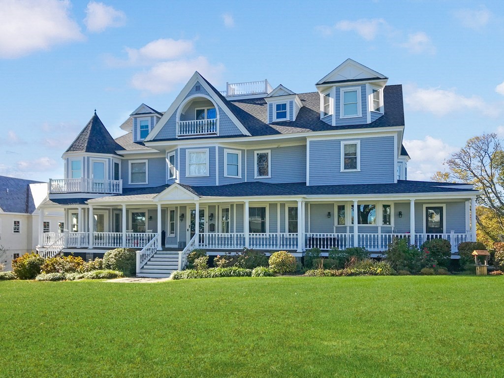 a front view of a residential houses with yard and green space