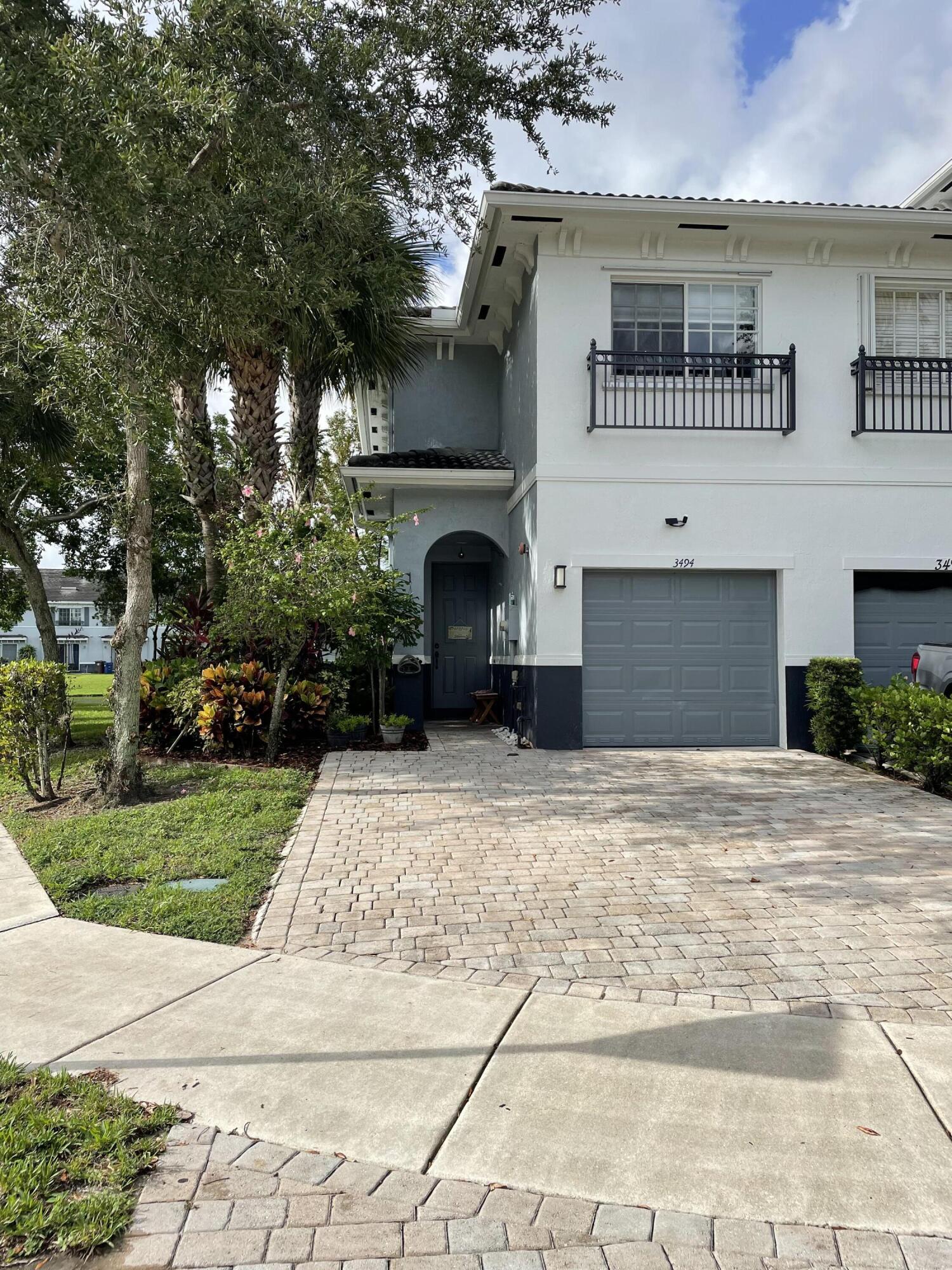 a front view of a house with a yard and a garage