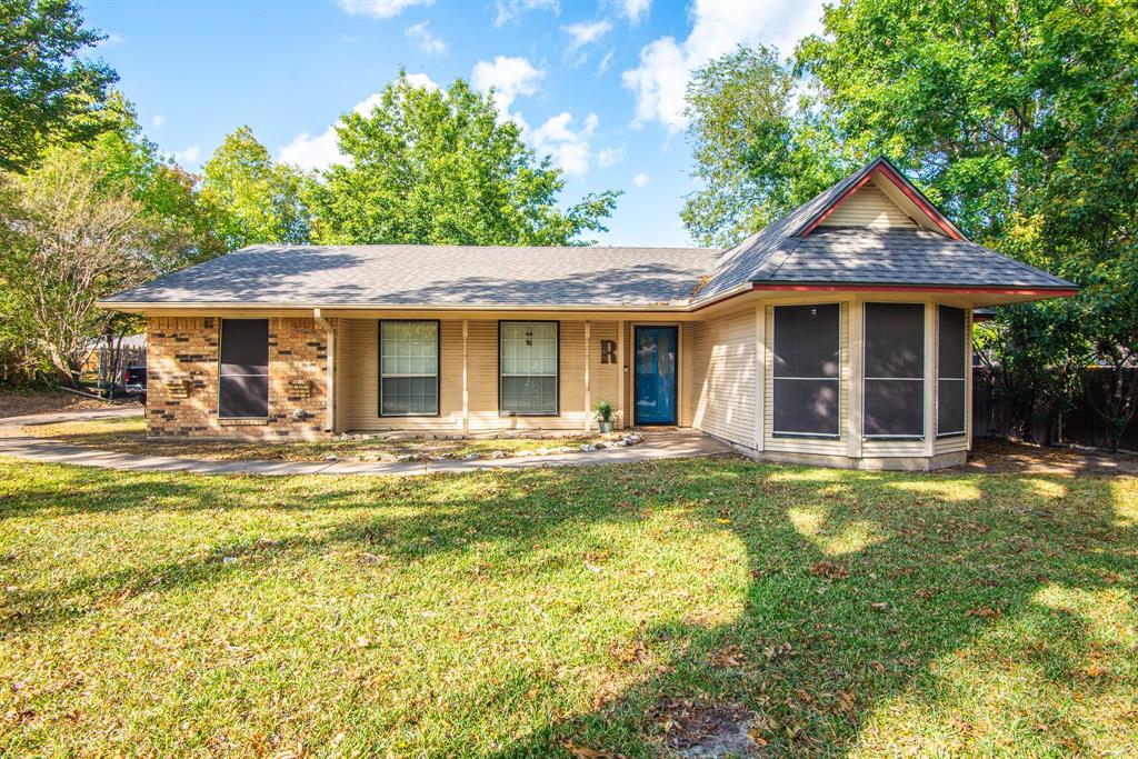 View of front of property with a beautiful front yard.