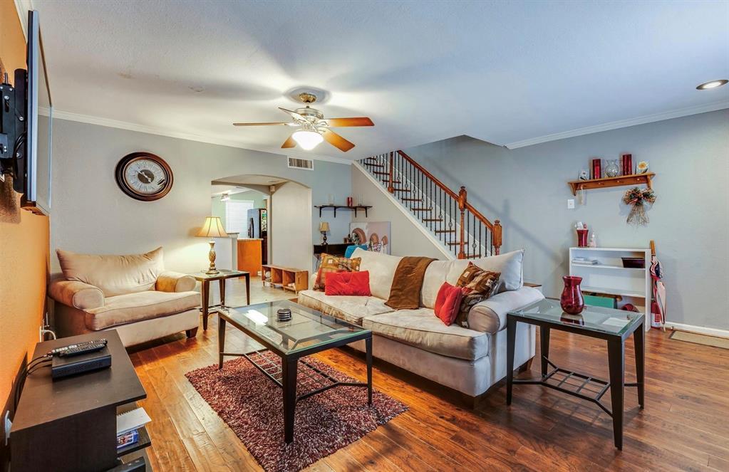 a living room with furniture and wooden floor