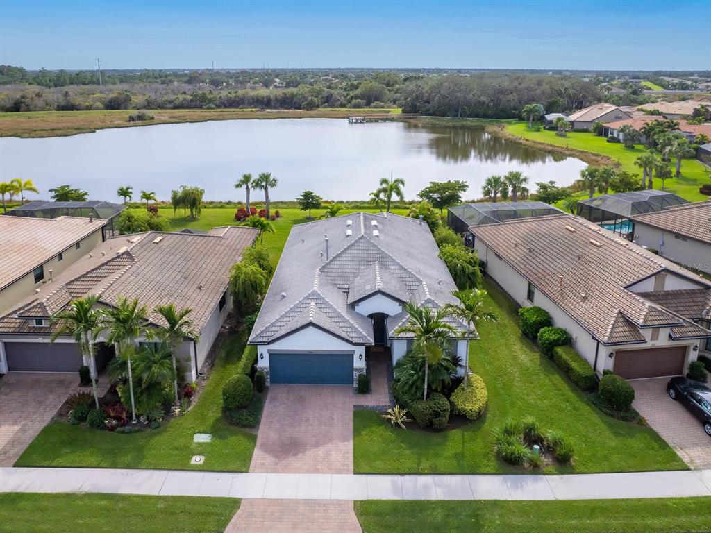 an aerial view of ocean with residential house with outdoor space and seating