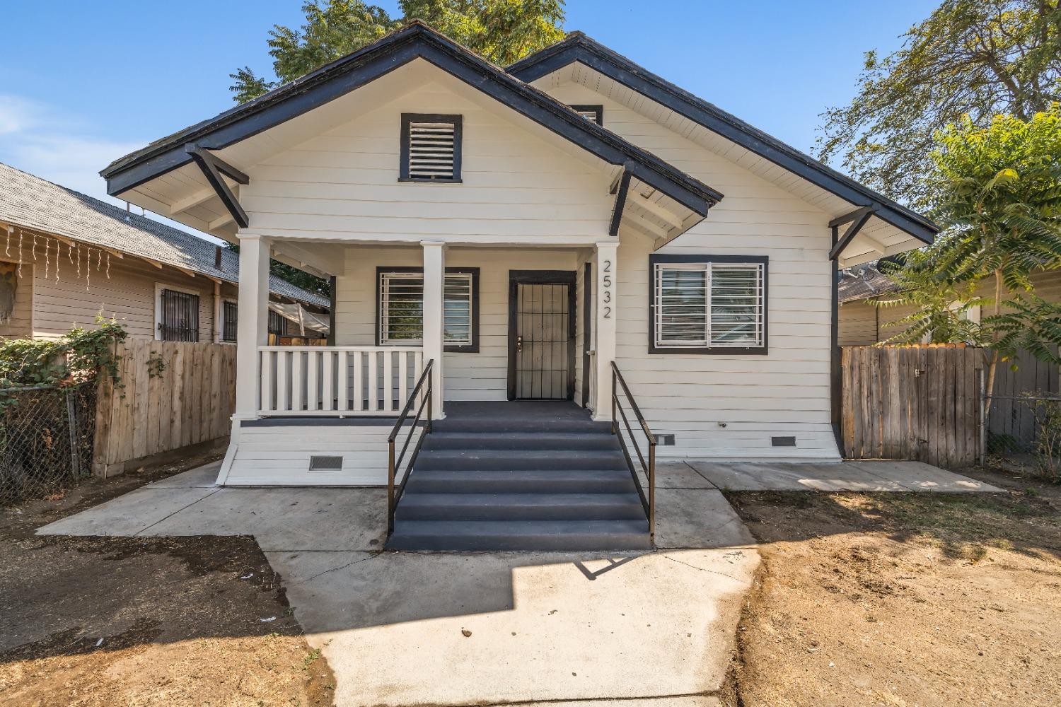 a view of a house with wooden fence