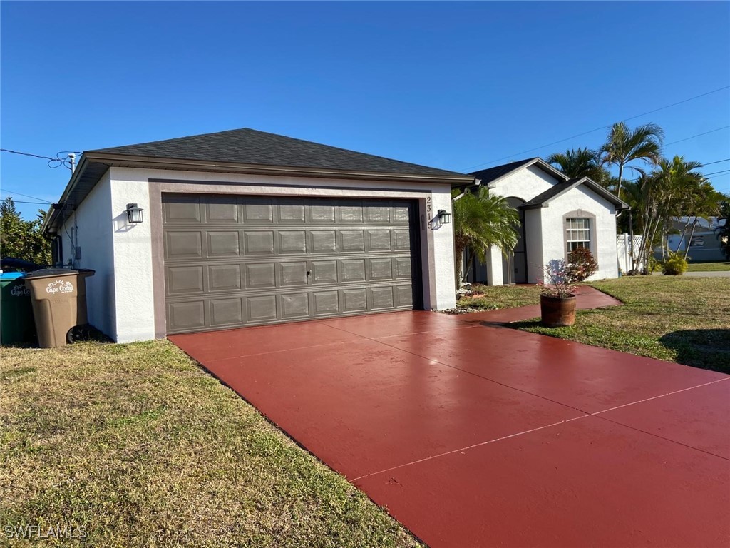 a view of a house with a backyard and a garage