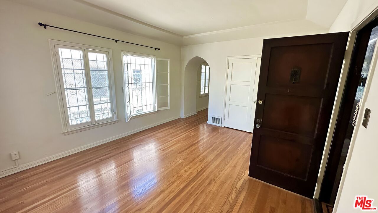 wooden floor in an empty room with a window