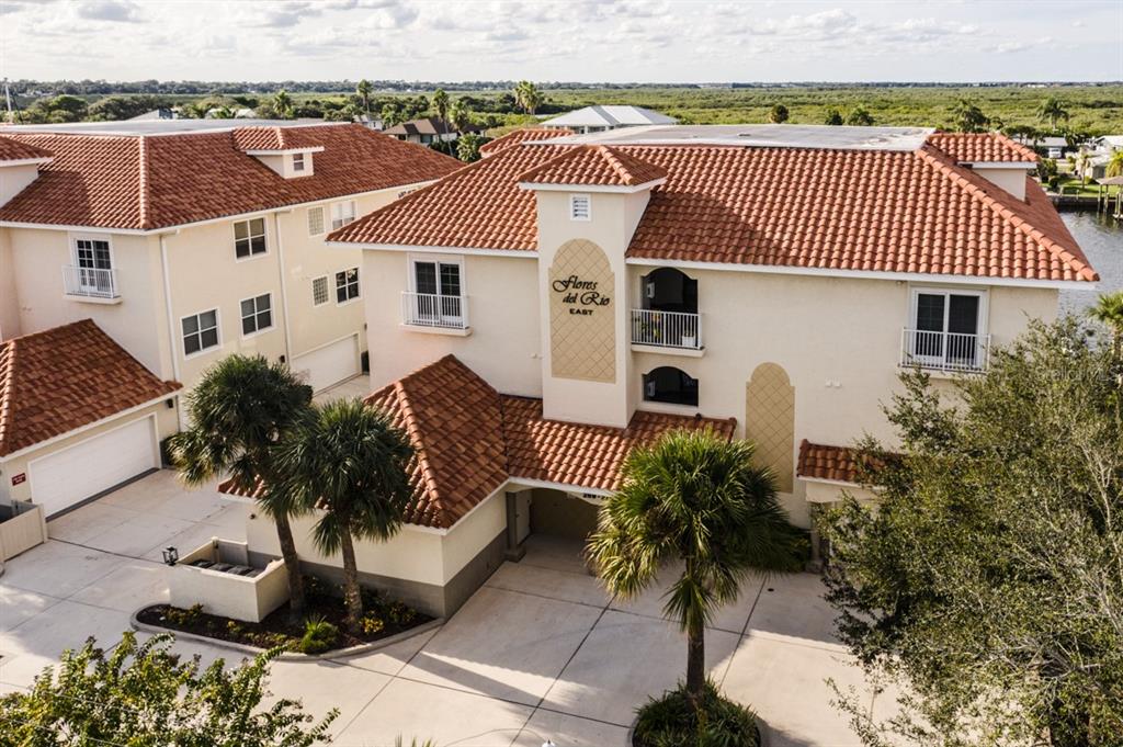 a aerial view of a house with a yard and potted plants