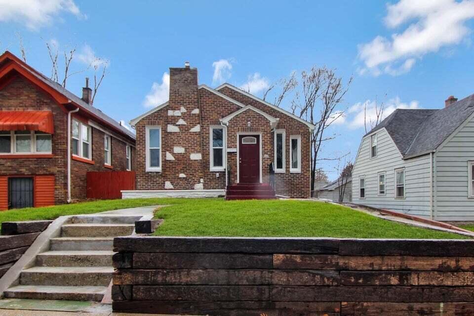 a front view of a house with garden