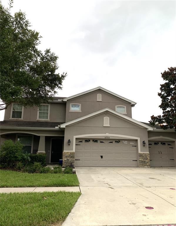 a front view of a house with a yard and garage