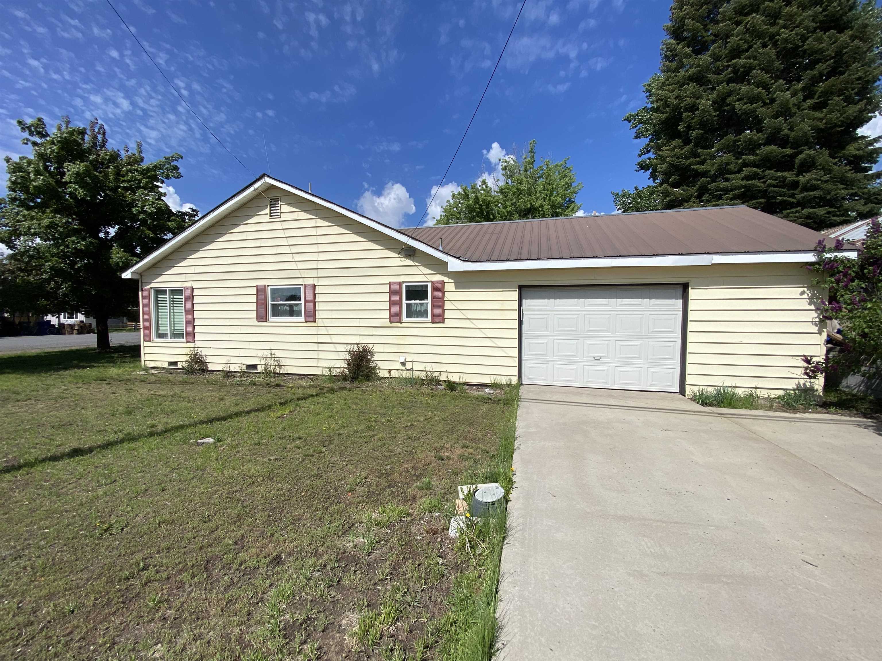 a view of a house with a yard and garage