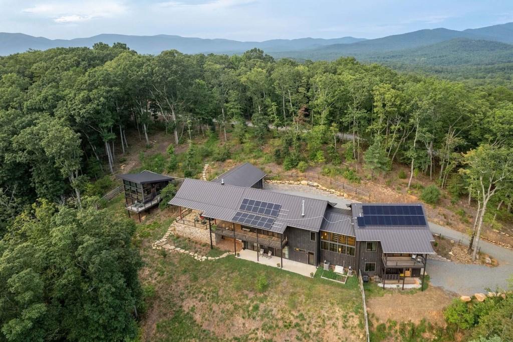 an aerial view of a house with pool lake view and mountain view