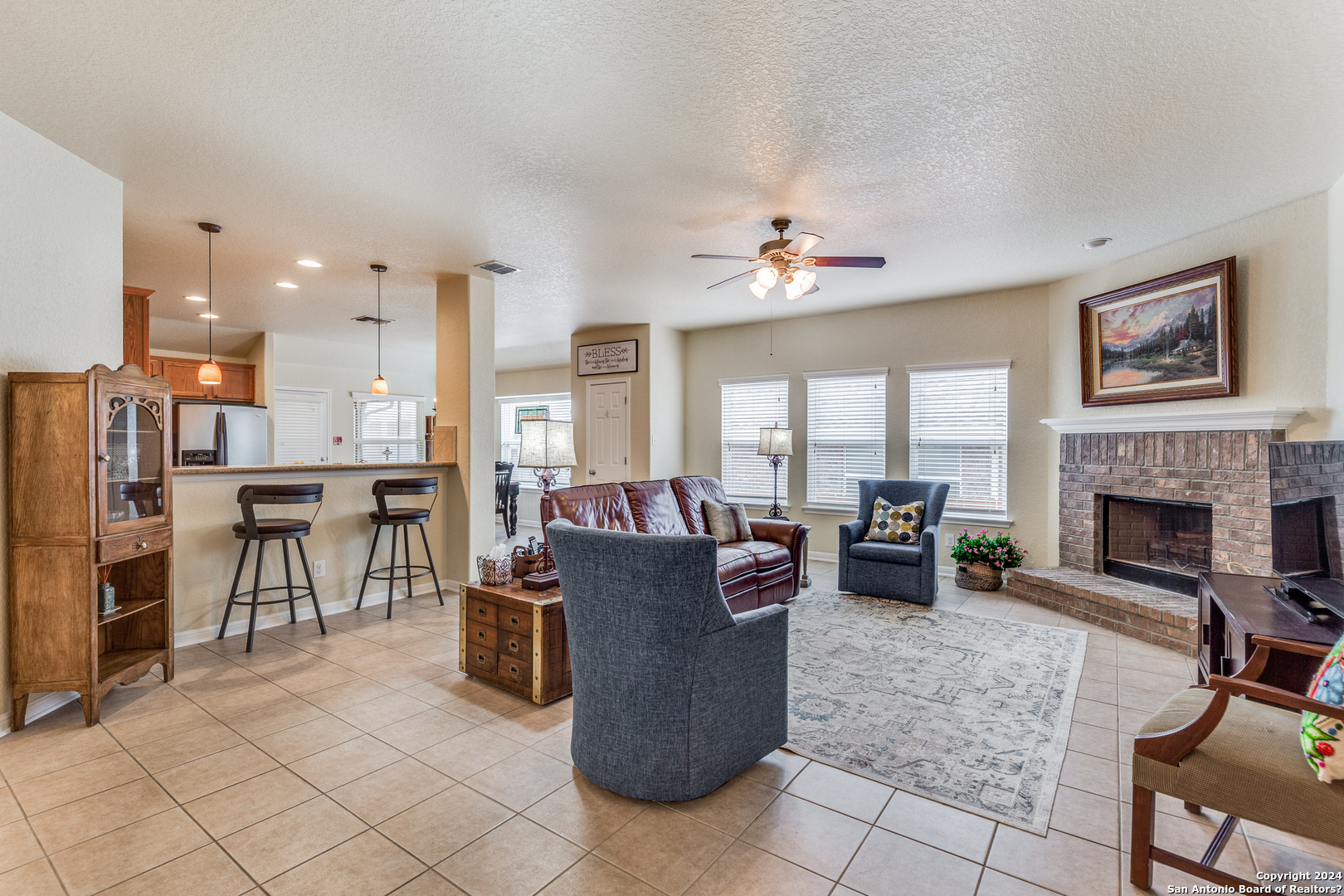 a living room with furniture a fireplace and a table