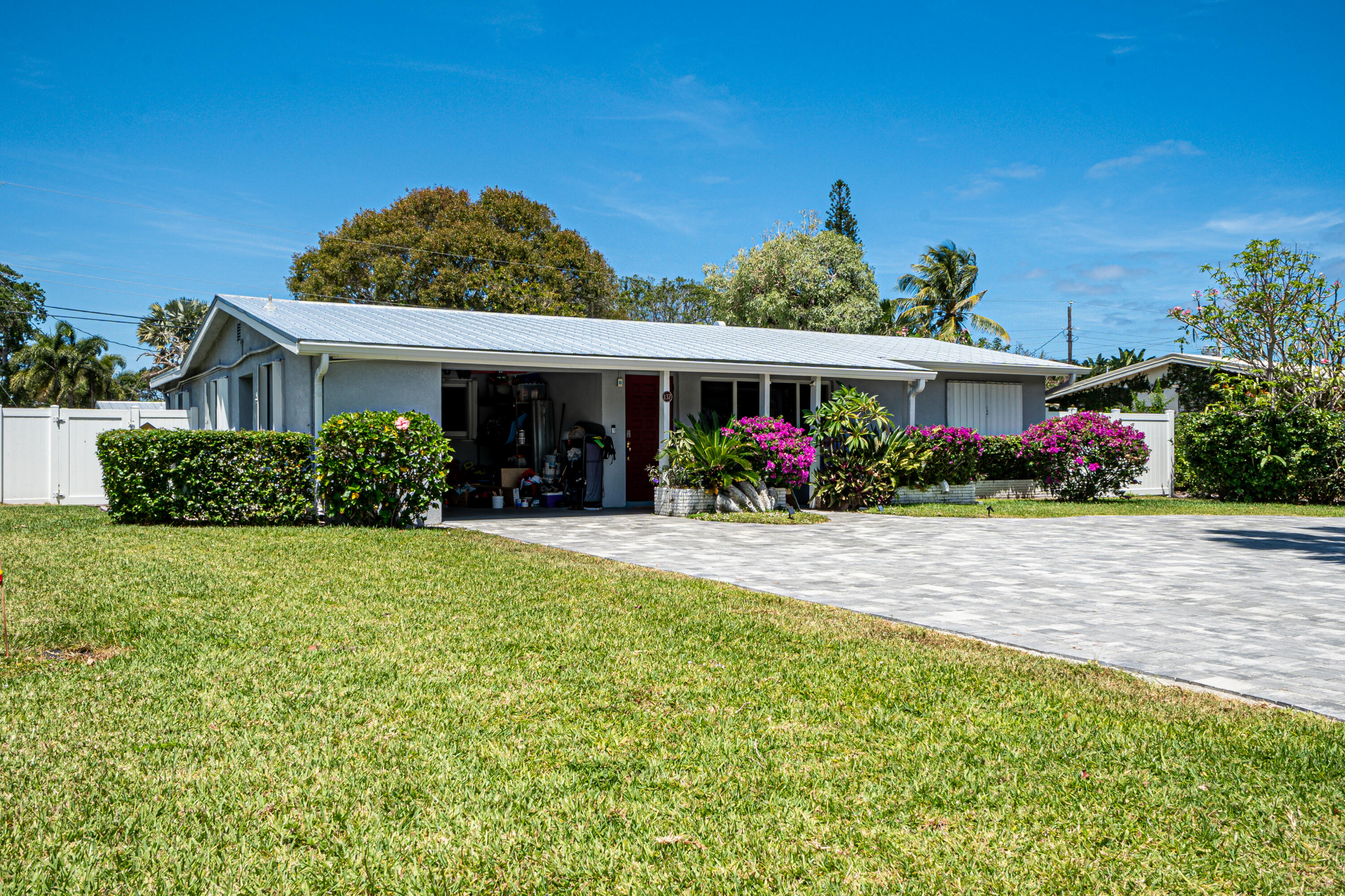 a front view of house with a garden