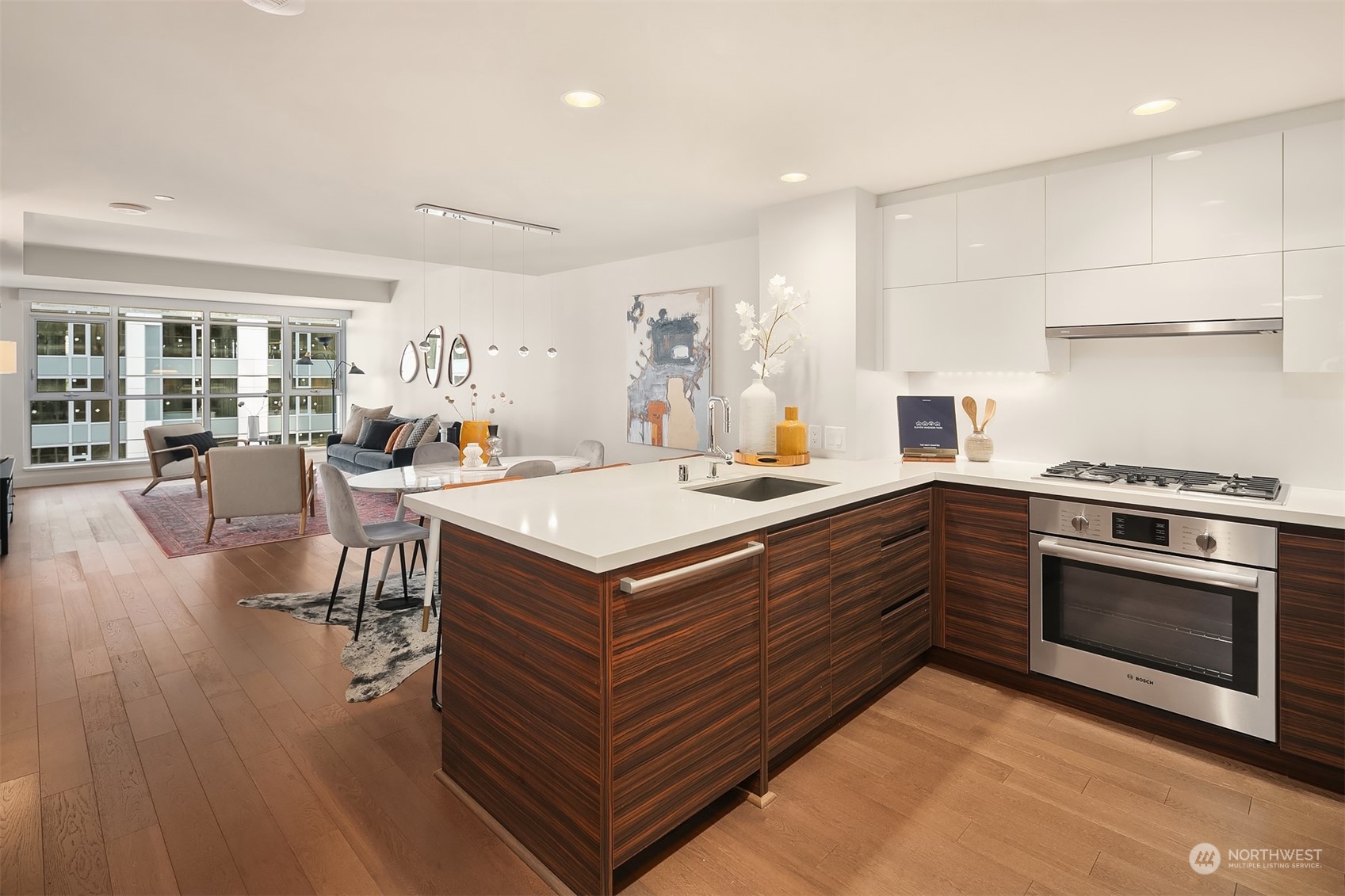 a kitchen with a stove a refrigerator and wooden floor