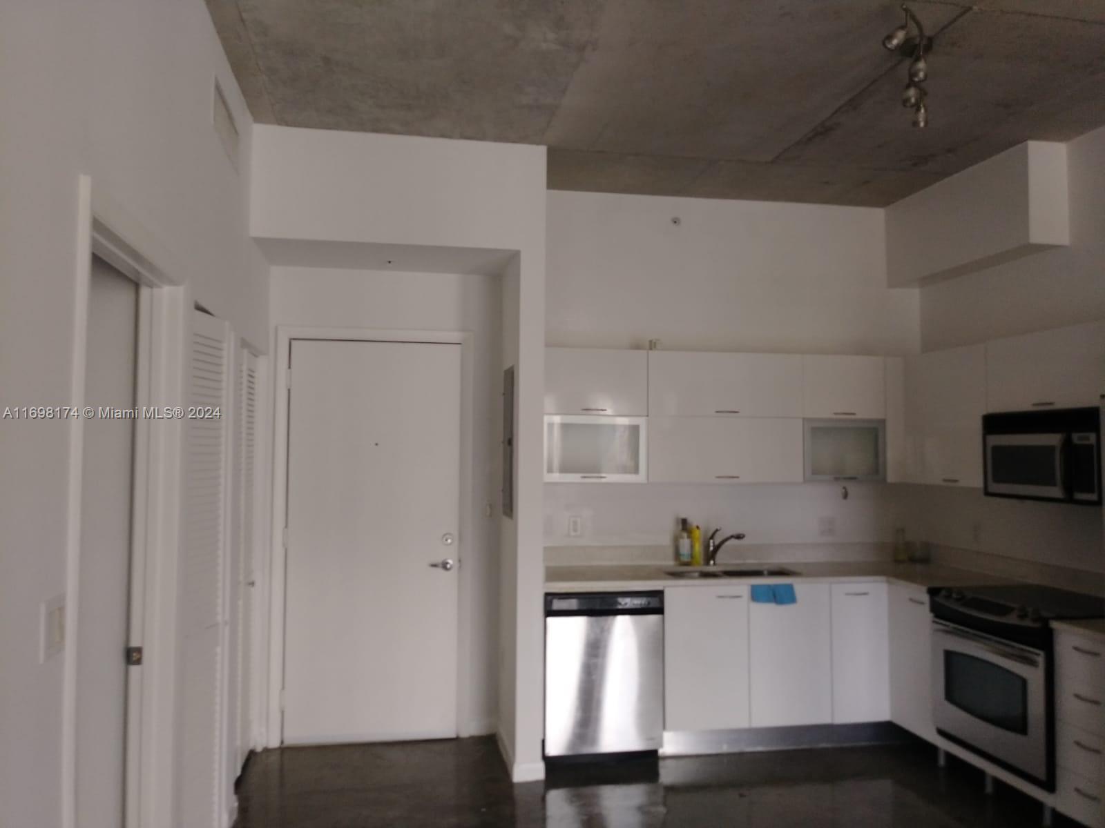 a kitchen with stainless steel appliances a refrigerator and a stove top oven