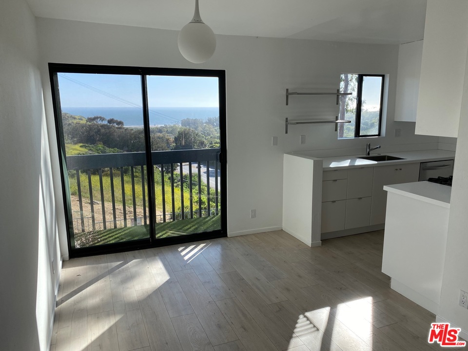 a view of a kitchen with a sink and dishwasher