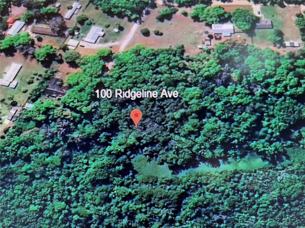 an aerial view of a house with a yard and garden