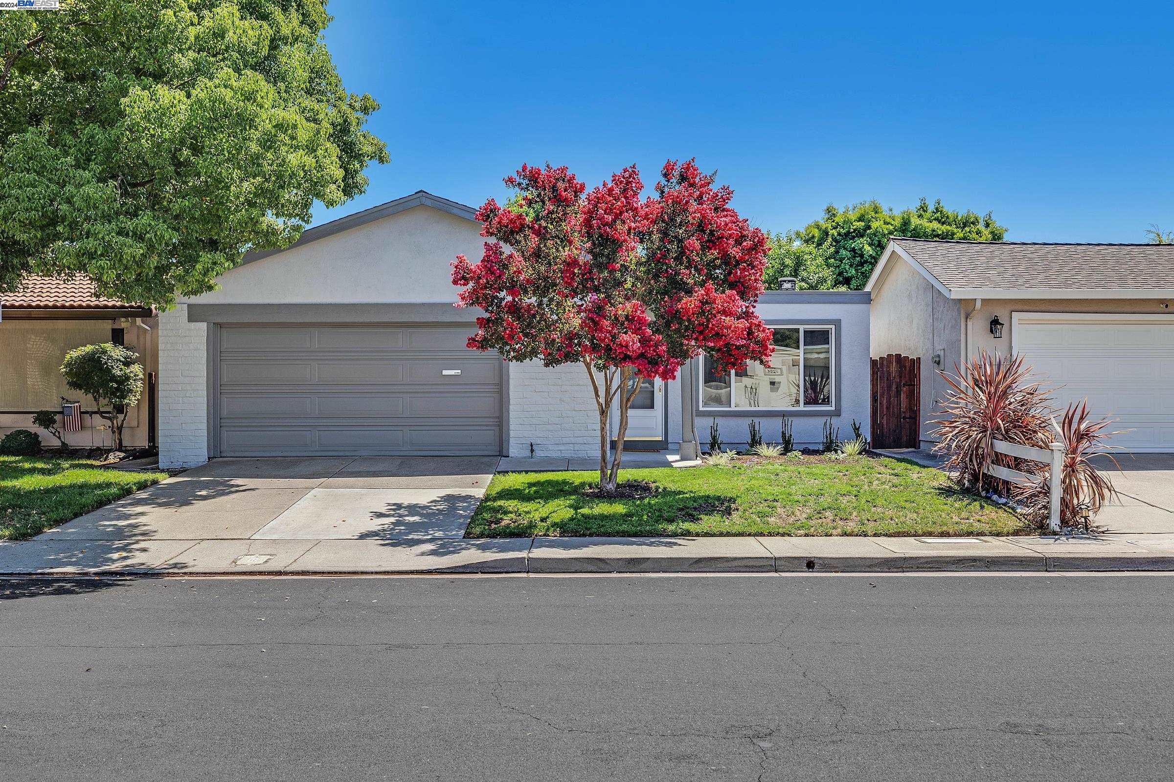 a front view of a house with a yard and a garage