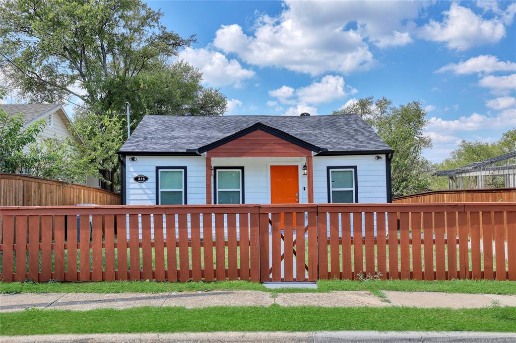 a view of a house with wooden fence