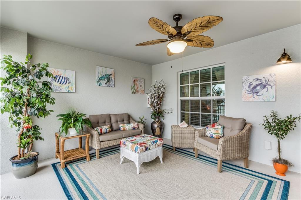 a living room with furniture potted plant and a window