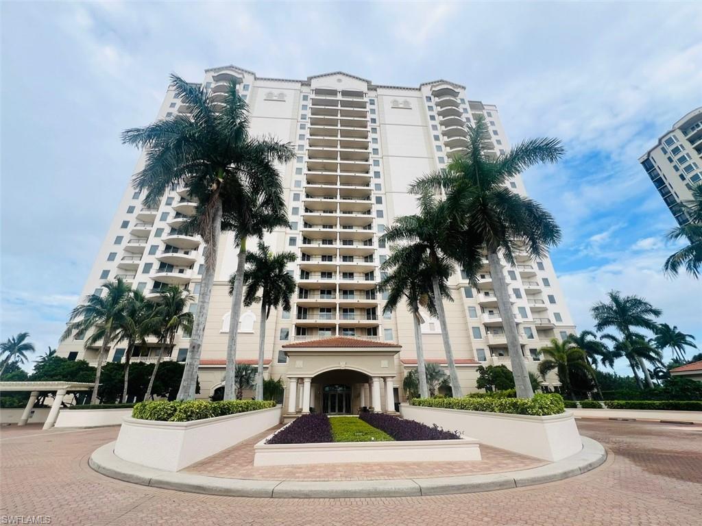 a view of multi story residential apartment building with a yard