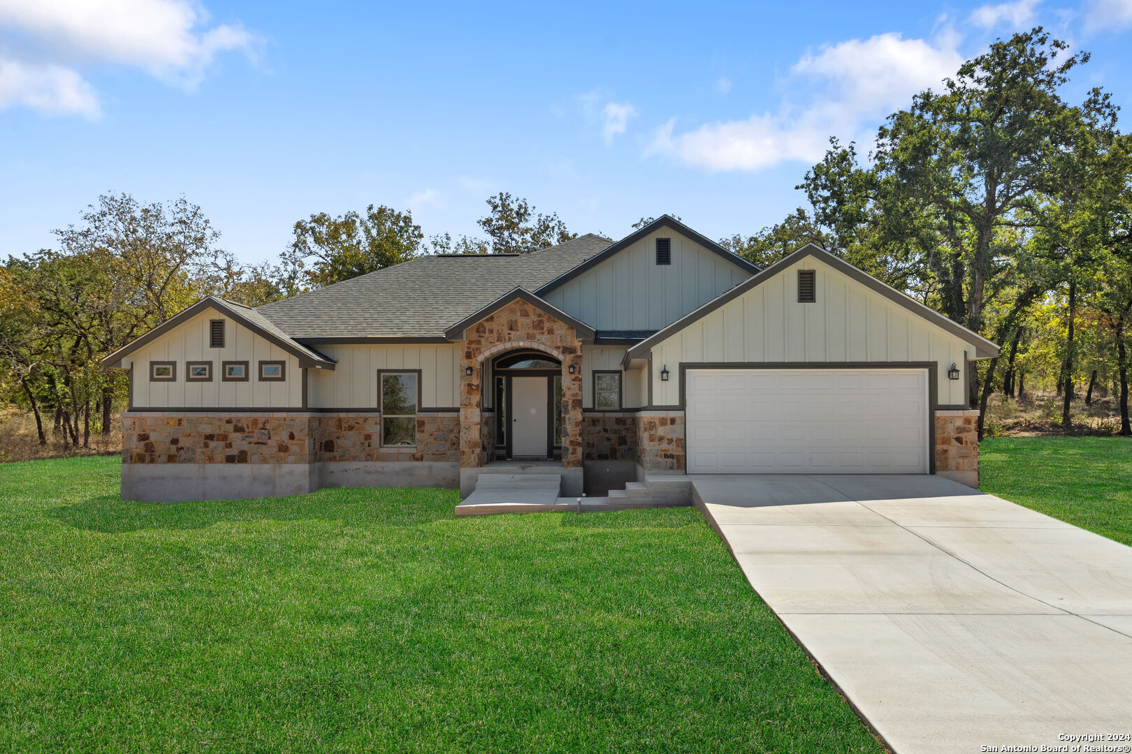 a front view of a house with a yard and garage