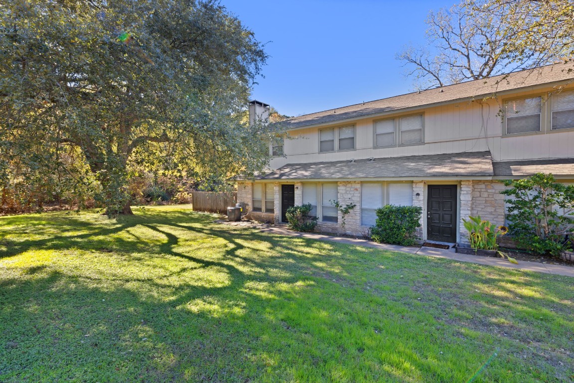 a view of a house with a yard and sitting area