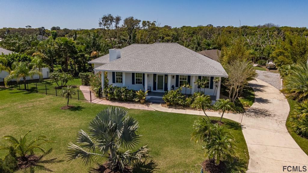 a aerial view of a house with swimming pool garden and patio