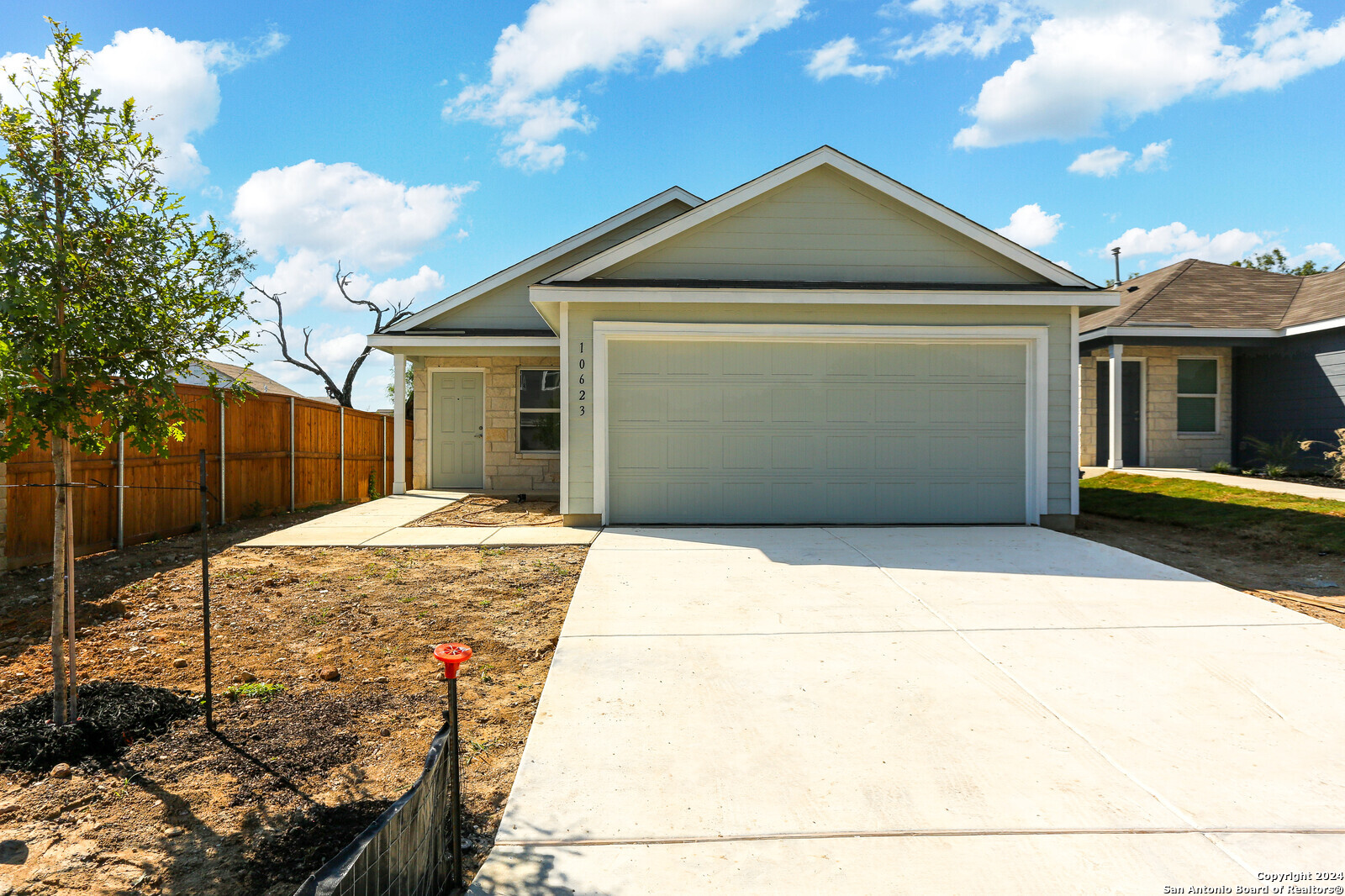 a front view of a house with garage