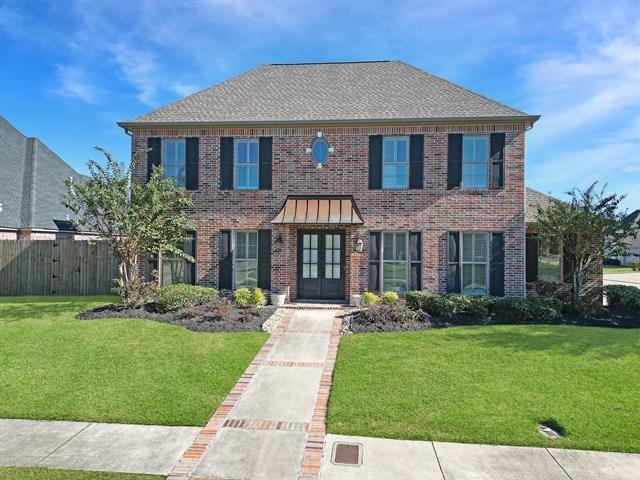 a front view of house with yard and green space