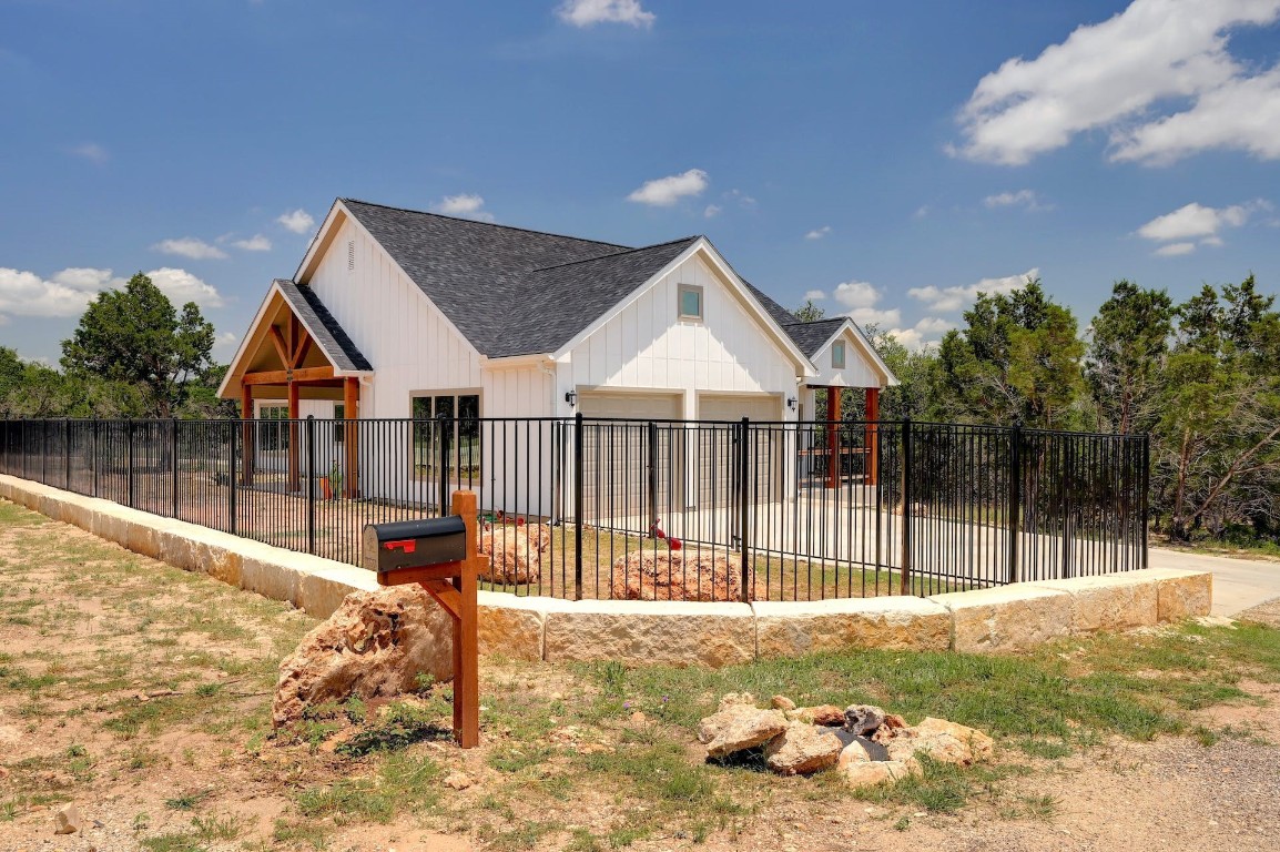 a view of a house with a wooden fence