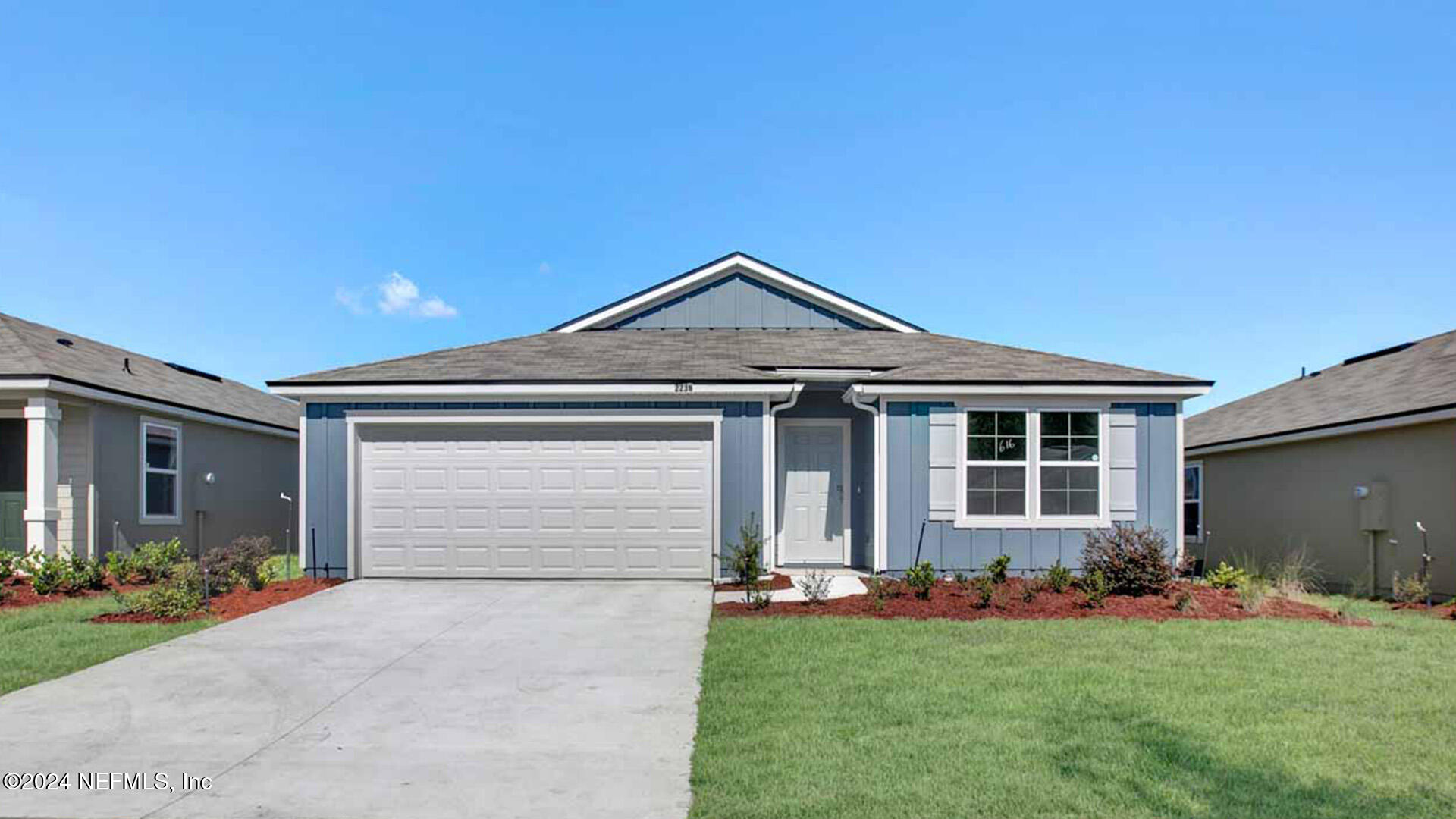 a front view of a house with a garden and yard