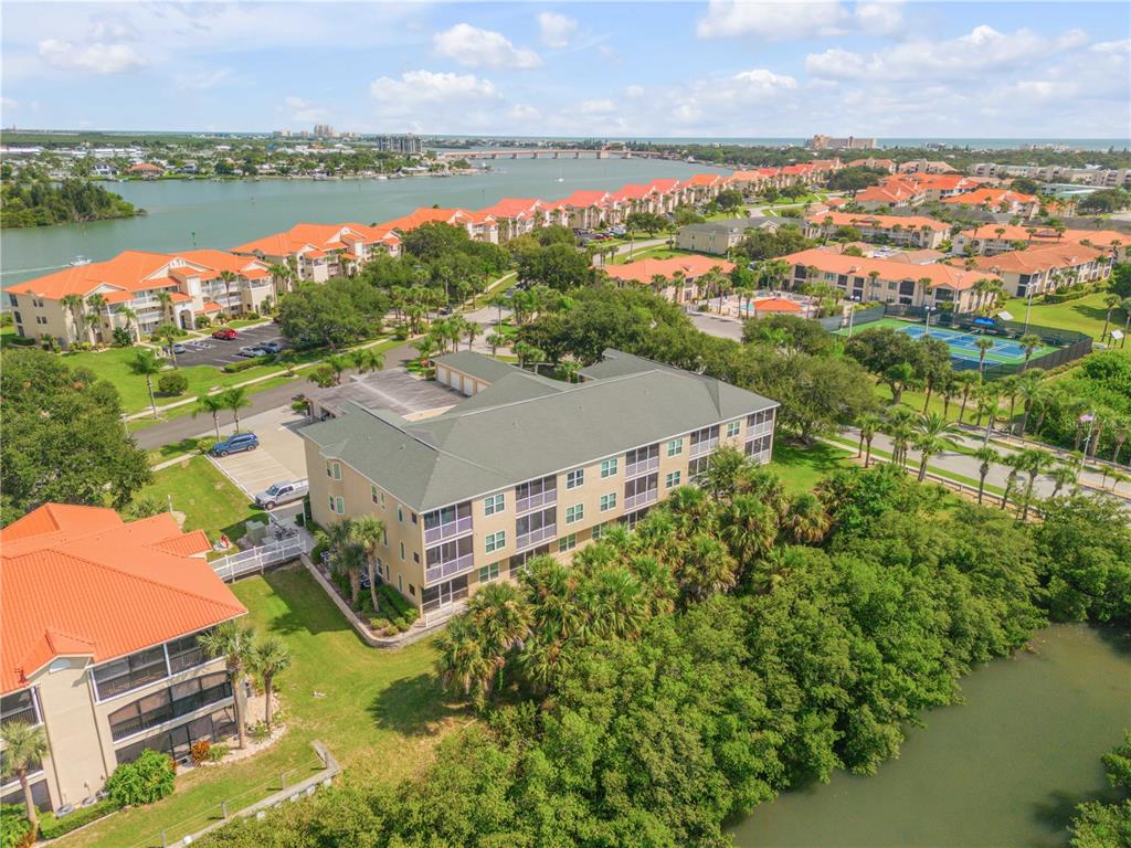 an aerial view of residential building with outdoor space and lake view