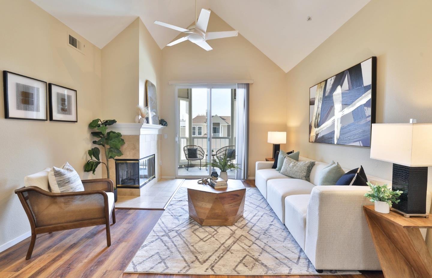 a living room with furniture potted plant and a large window