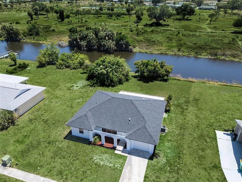 an aerial view of a house with a yard