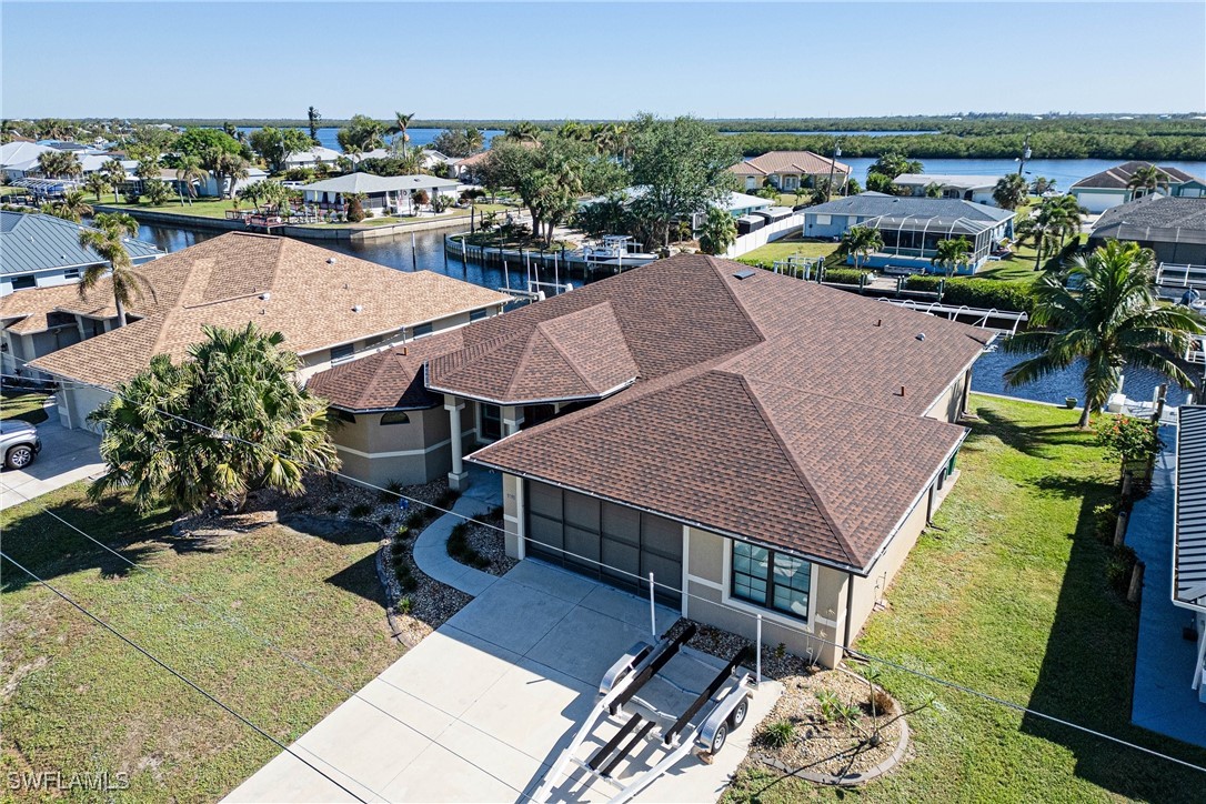 a aerial view of a house with swimming pool and furniture