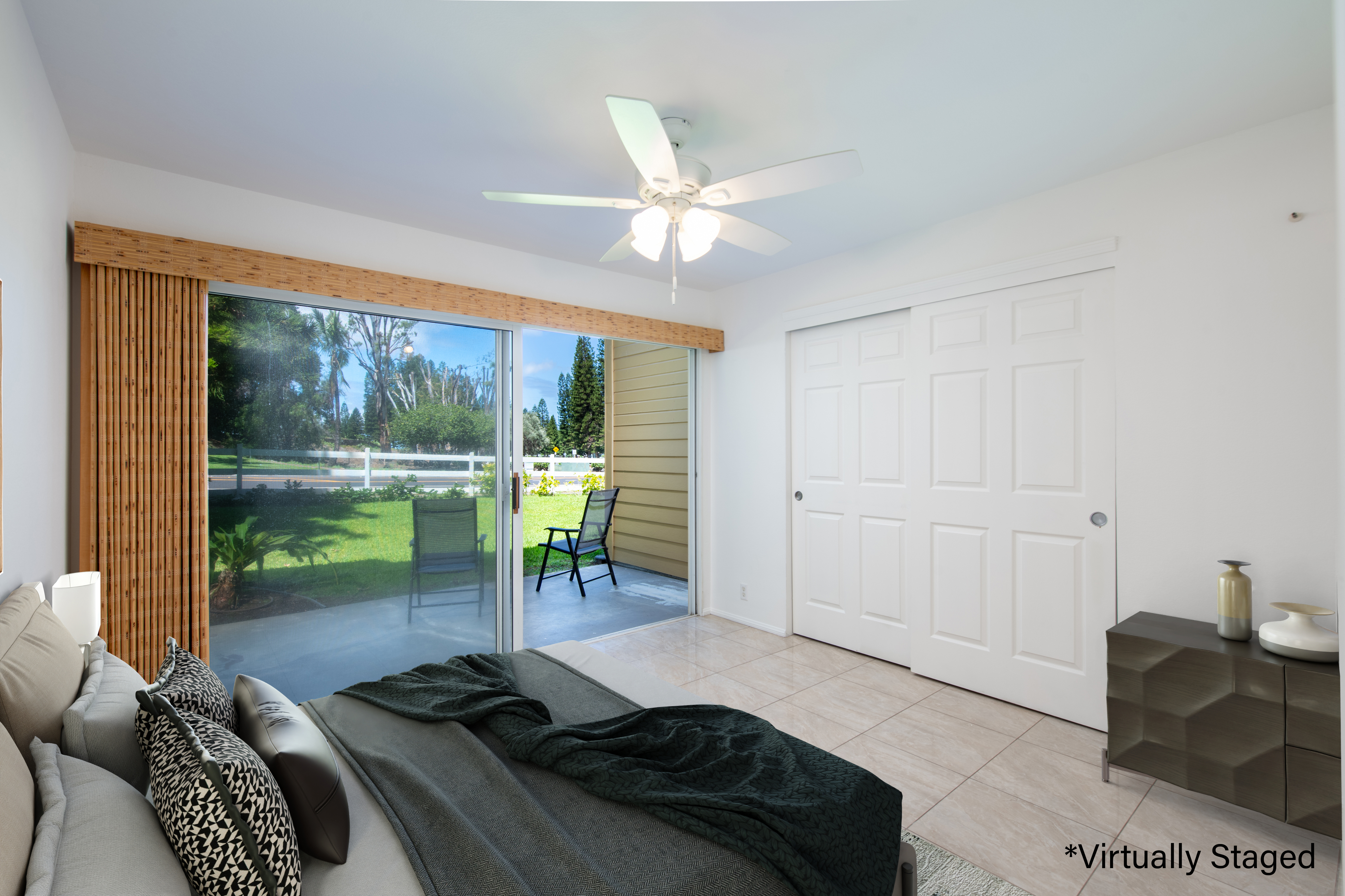 a bedroom with a bed and a large window with balcony view