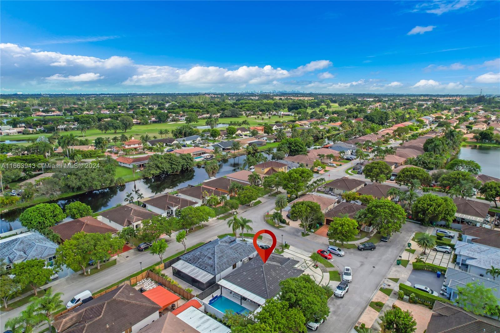 an aerial view of residential houses with outdoor space and trees