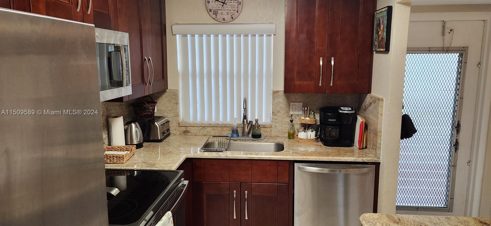 a kitchen with a sink refrigerator and cabinets