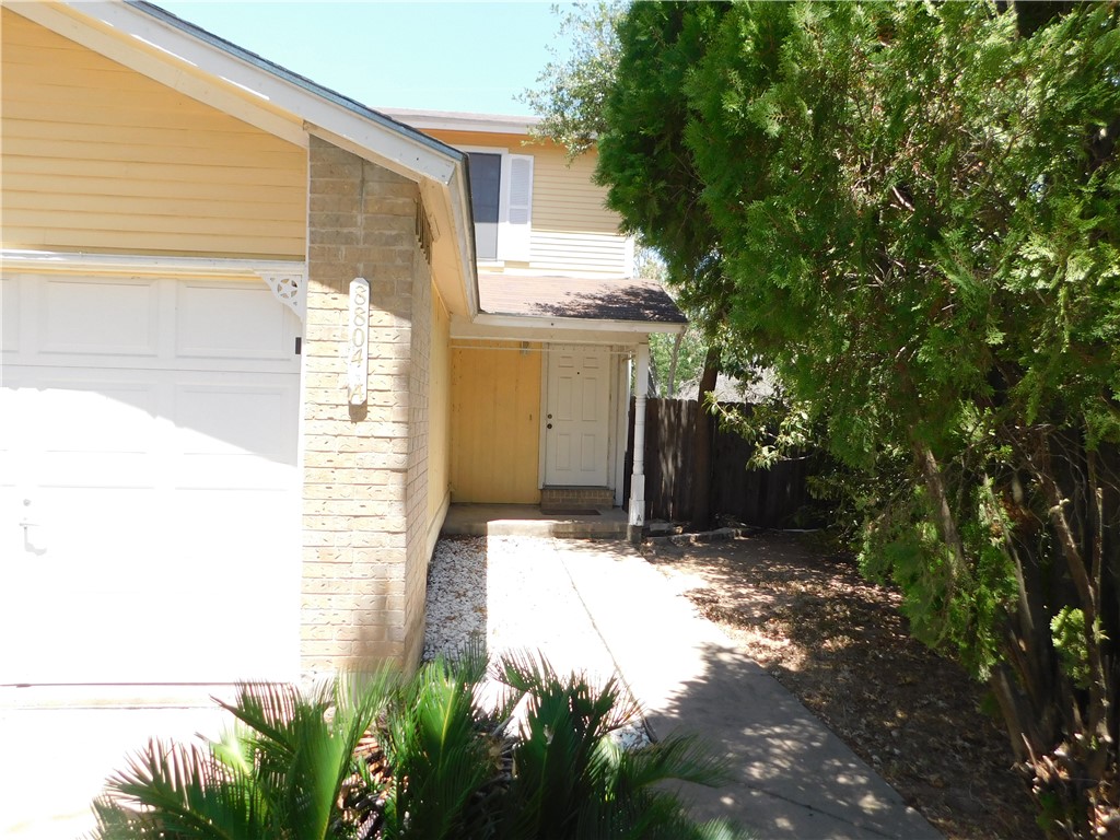 a view of house with backyard and garden