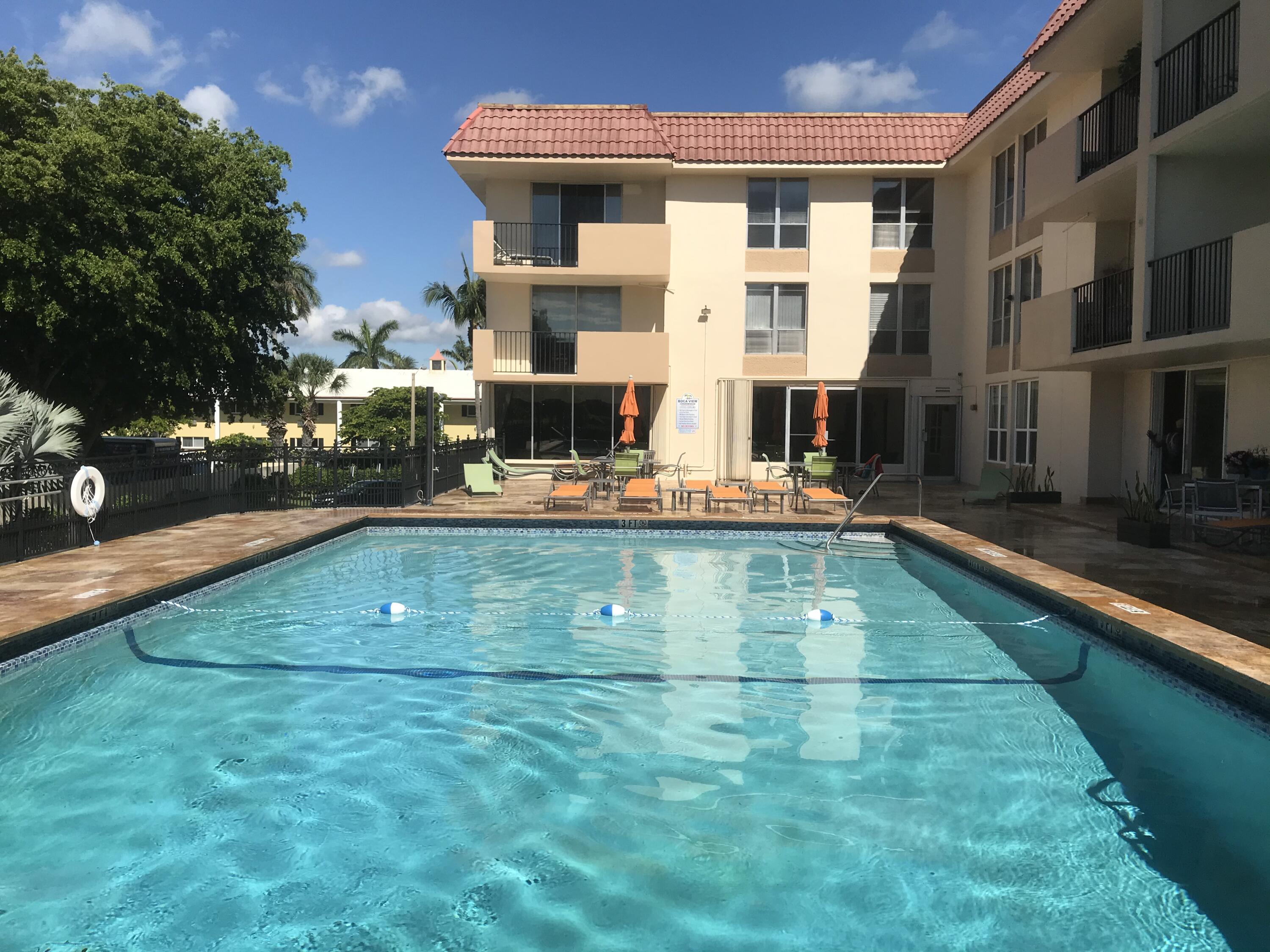 an outdoor view of swimming pool with outdoor seating