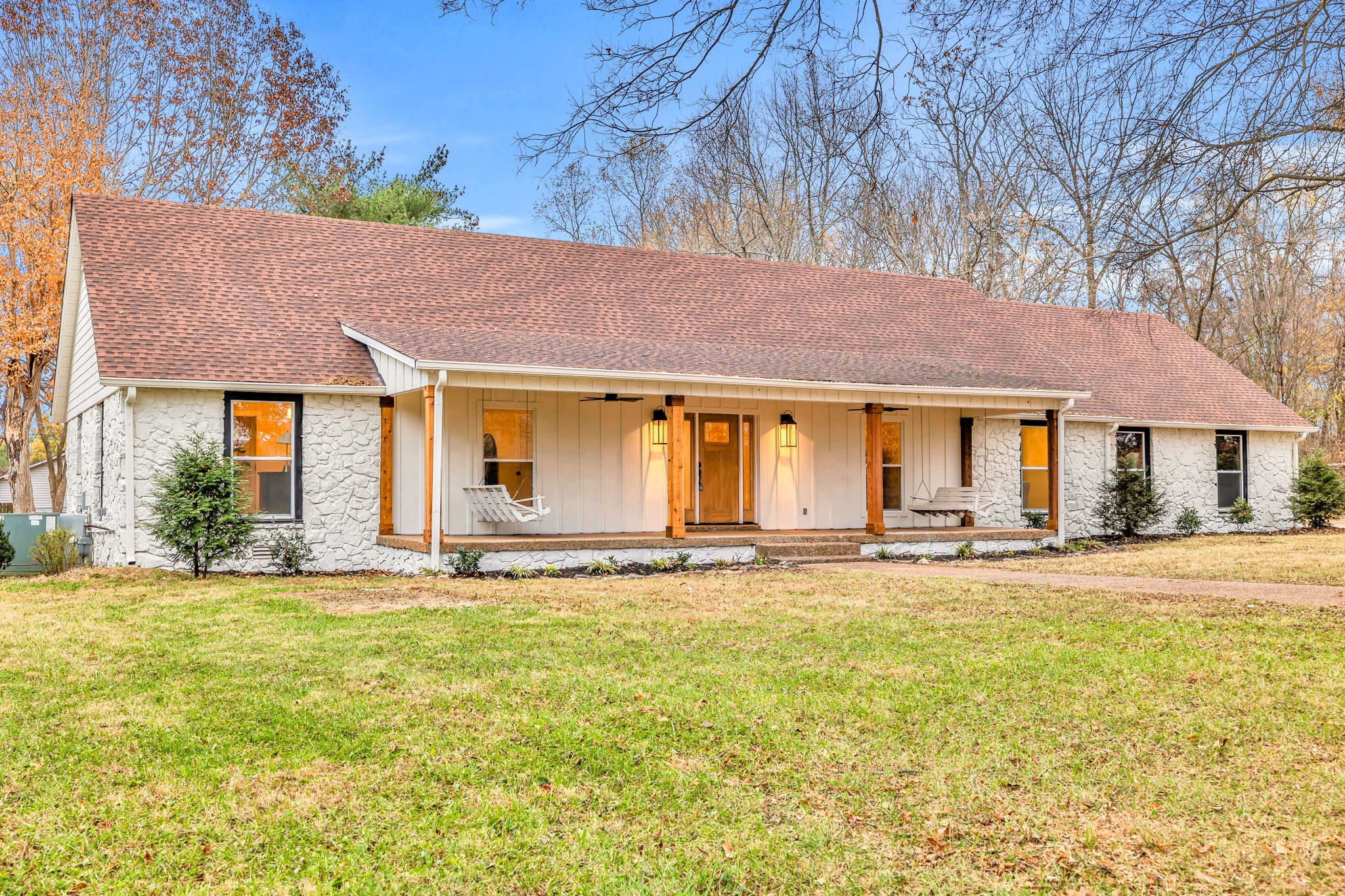 a view of a house with a yard and sitting area