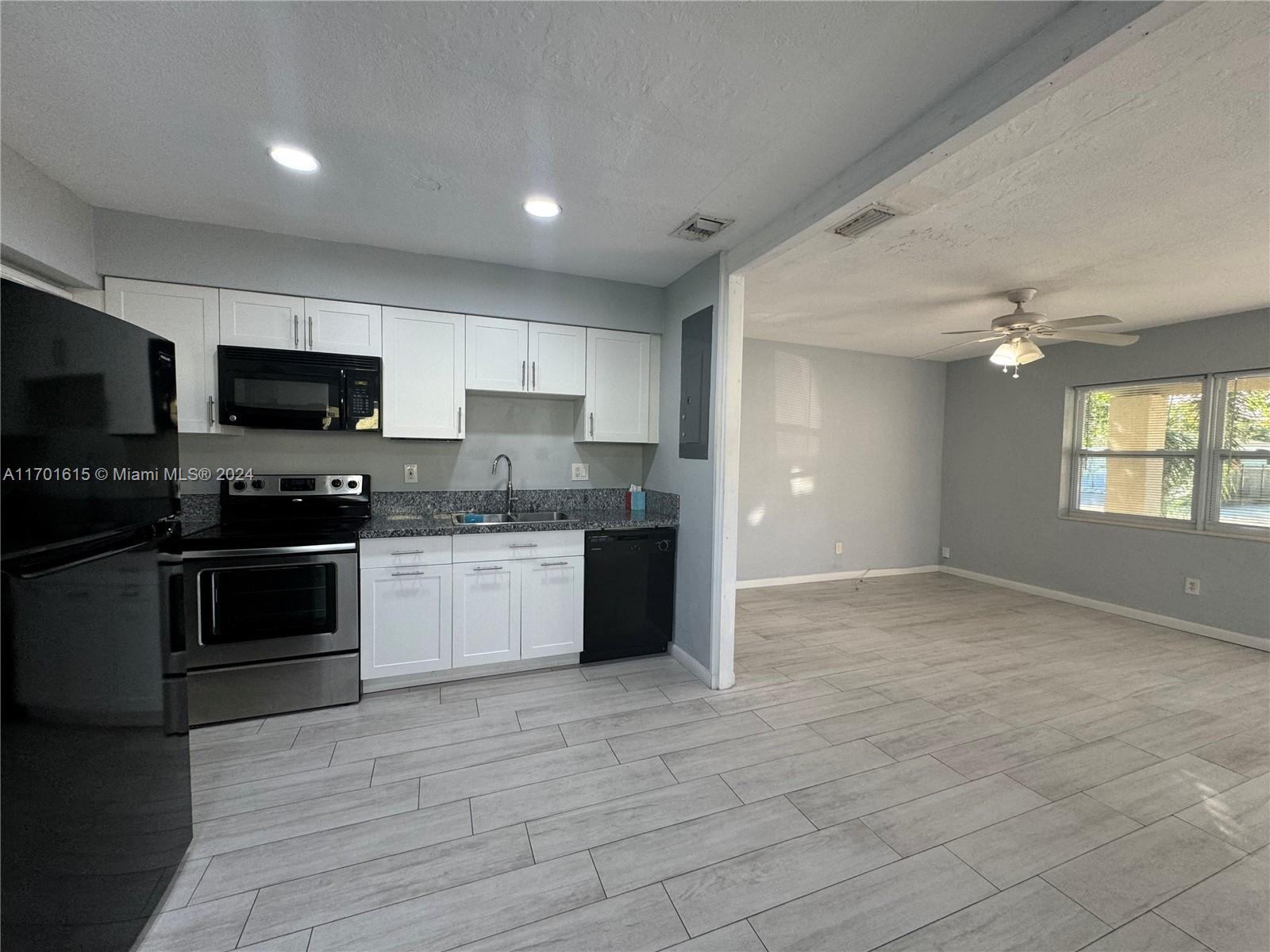 a kitchen with granite countertop a stove and a sink