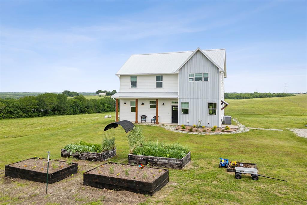 a view of a house with yard and lake view