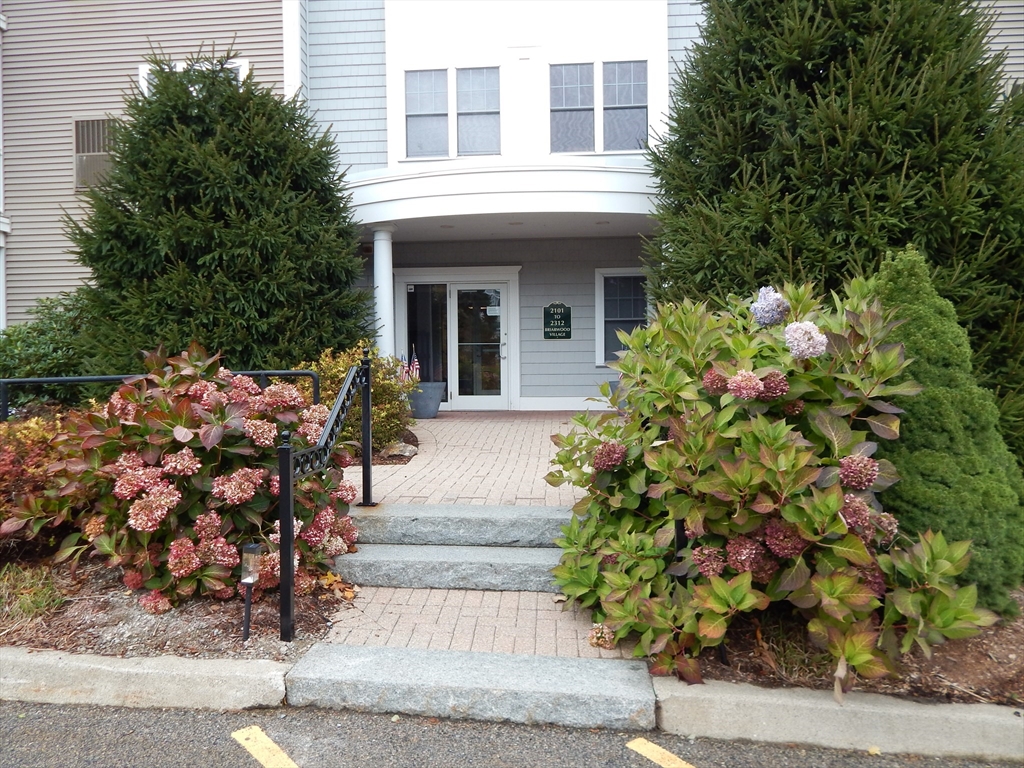 front view of a house with a flower garden